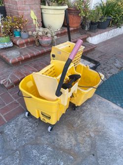 Used yellow commercial mop buckets