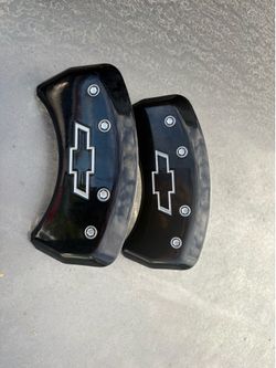 Chevy bowtie MGP brake caliper covers feature by a black finish