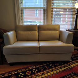 Barely Used Ivory Leather Loveseat Currently available at Cardi's for $980