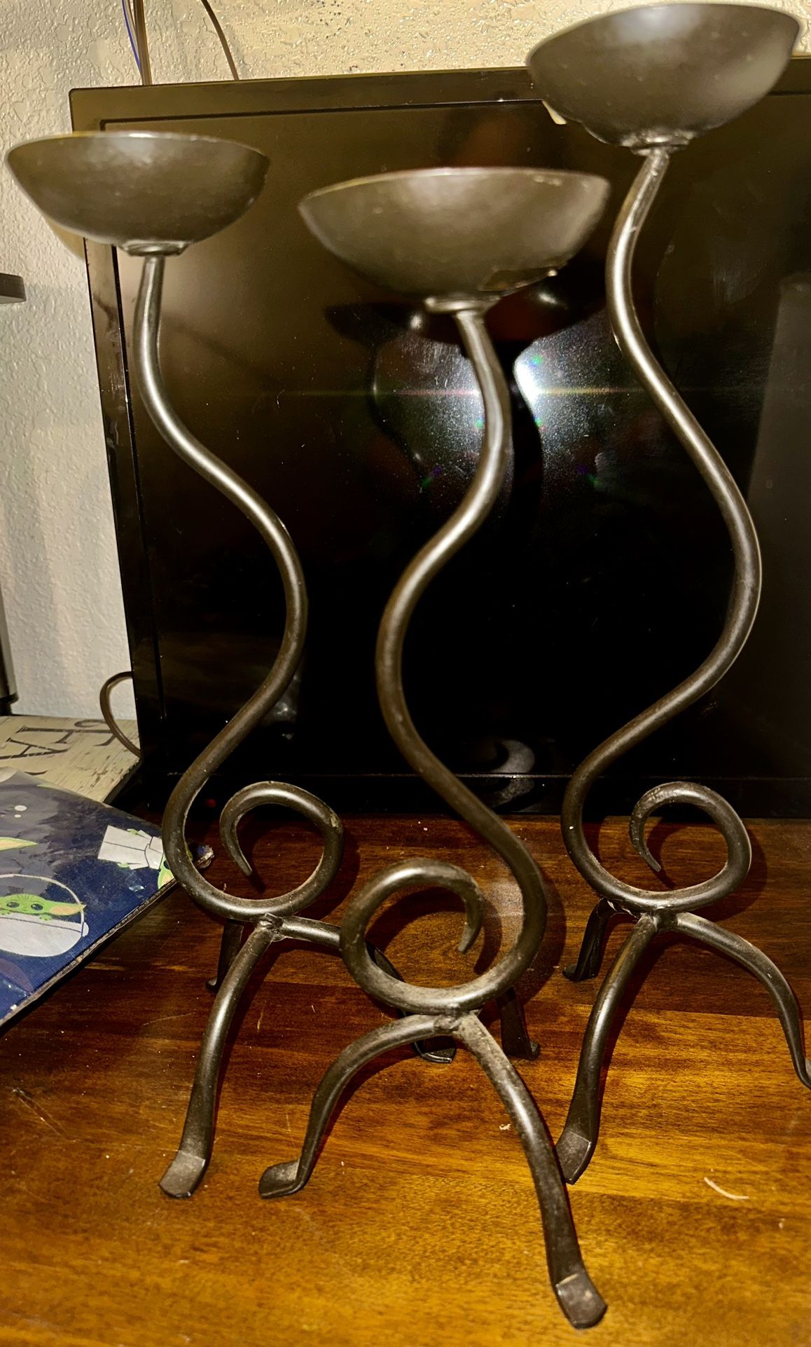 Preowned Set of 3 pillar Candle Holders, cast iron, in three staggered heights.  in excellent condition.  Features: • Staggered sizes: 15 inch, 14 inc