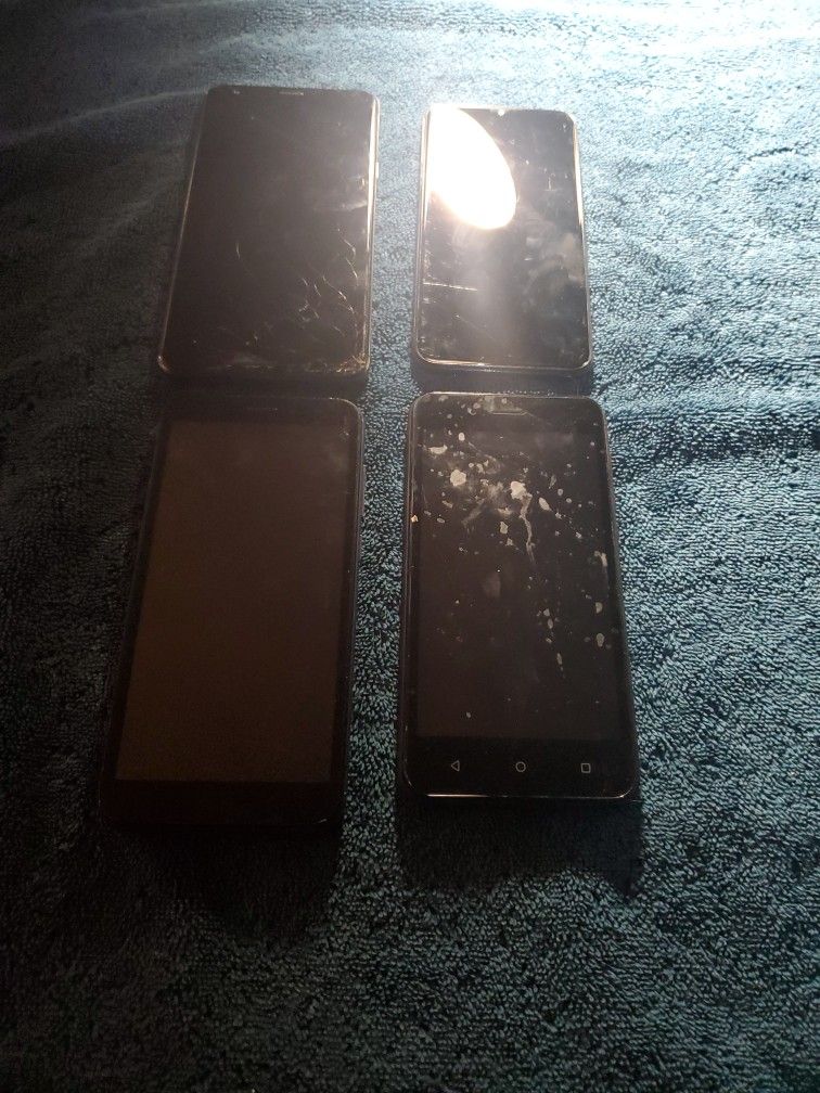 BAG OF 4 CELL PHONES.