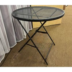 Black metal mesh folding patio bistro table. Folding outdoor patio deck round table