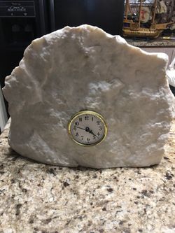 Stone statue with clock