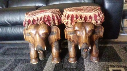Two elephants solid wood excellent condition no cracks going as a pair pretty heavy you can use them as your foot rest or chair
