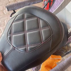 Harley Davidson: Black passenger seat featuring red stitching.