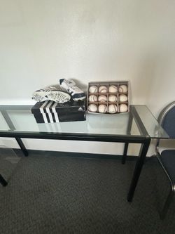 Baseballs and pair of cleats