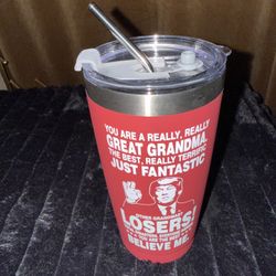 red stainless steel insulated coffee tumbler with a black lid and straw, featuring a humorous