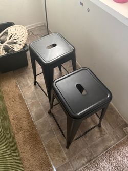 Two metal stool chairs
