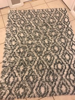 Grey and white rug. 48 in X 66 inches.
