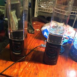 pair of clear colored water bluetooth speakers