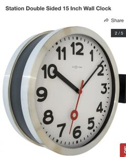 New station double-sided wall clock made of aluminum and glass.