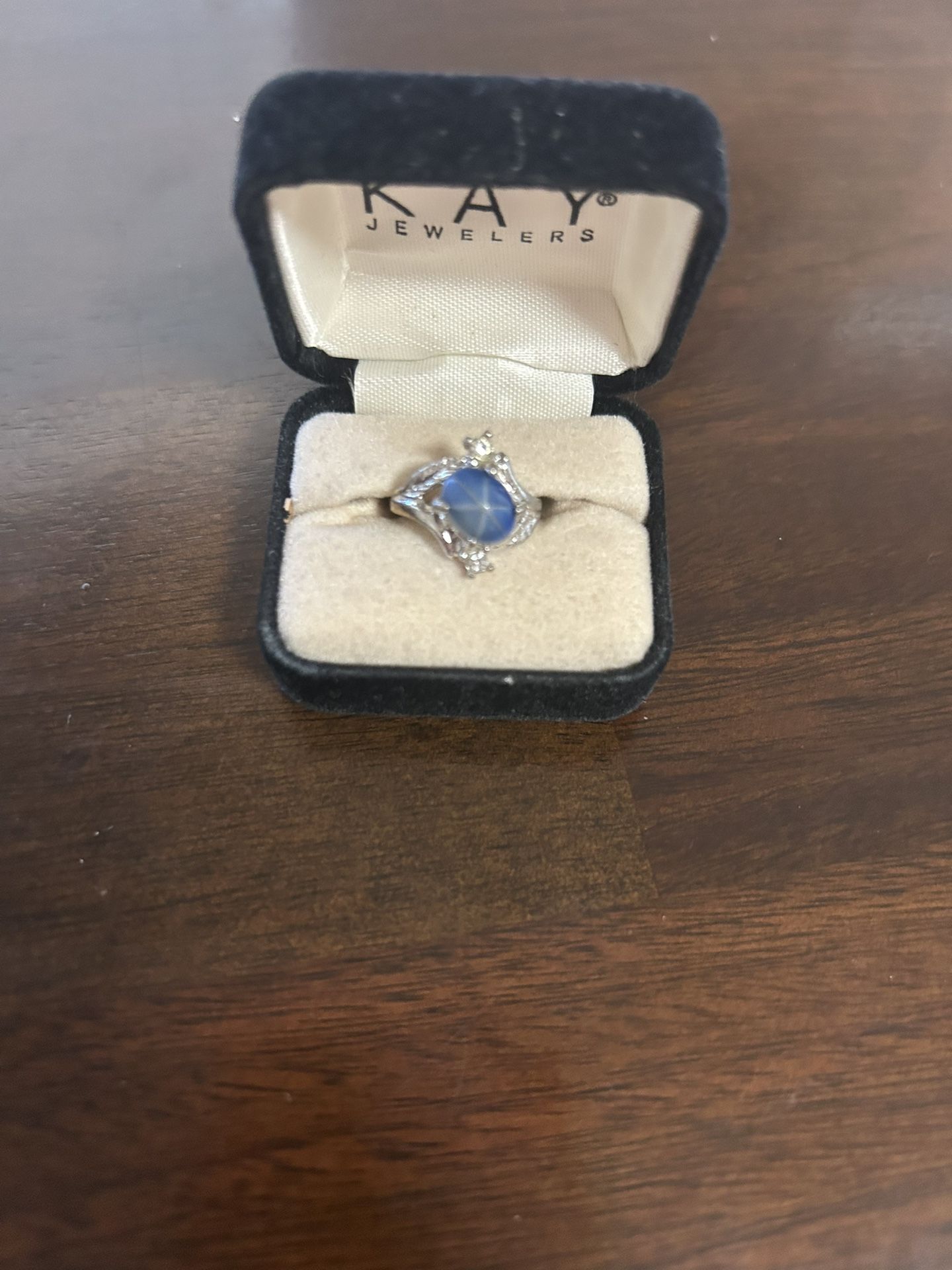 Ring with Star Sapphire, And Surrounded By Smaller Crystals From Kay Jewelers