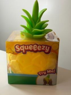 Squeeeezy pineapple kids toy with bright green topper and yellow body.