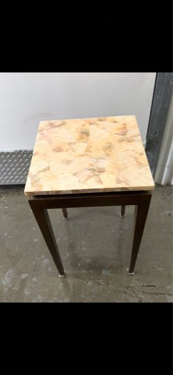 modern corner table features a square tabletop