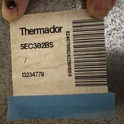 Thermador 30” double oven in cabinets with drawer.