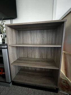 TWO grey bookshelves