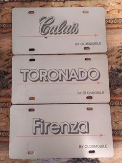 Rare vintage Oldsmobile Firenza/Tornado/Calais dealership license plates, '80's, plastic