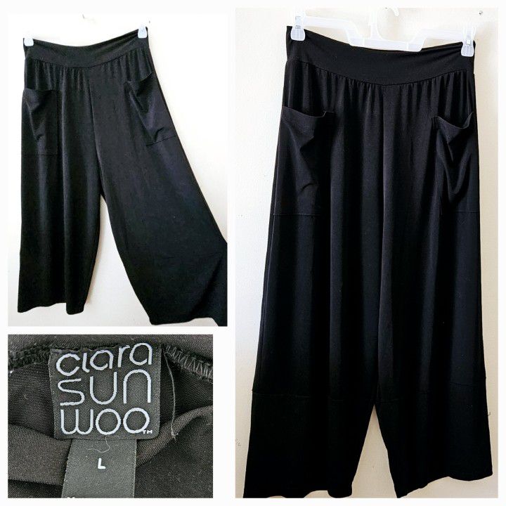 Size Large Clara Sun Woo Black Casual Dress Pants with Elastic Waist, Pockets and Flared Leg Design. 70% Polyester, 20% Rayon, 10% Spandex. 

Measures