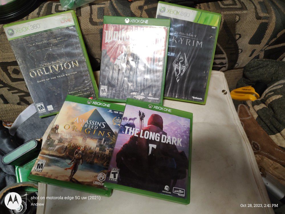 Three Xbox One Games Wolfenstein 2 Assassin's Creed Origins And The Long Dark And Two Xbox 360 Games The Elder Scrolls For Oblivion And The Elder Scro