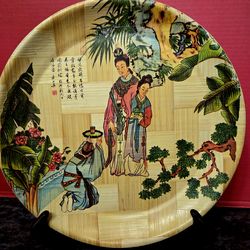 Vintage bamboo decorative plate titled "The Tipsy Dancer". 12.75"