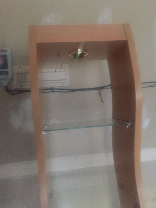 Wood cabinet with glass shelves and light