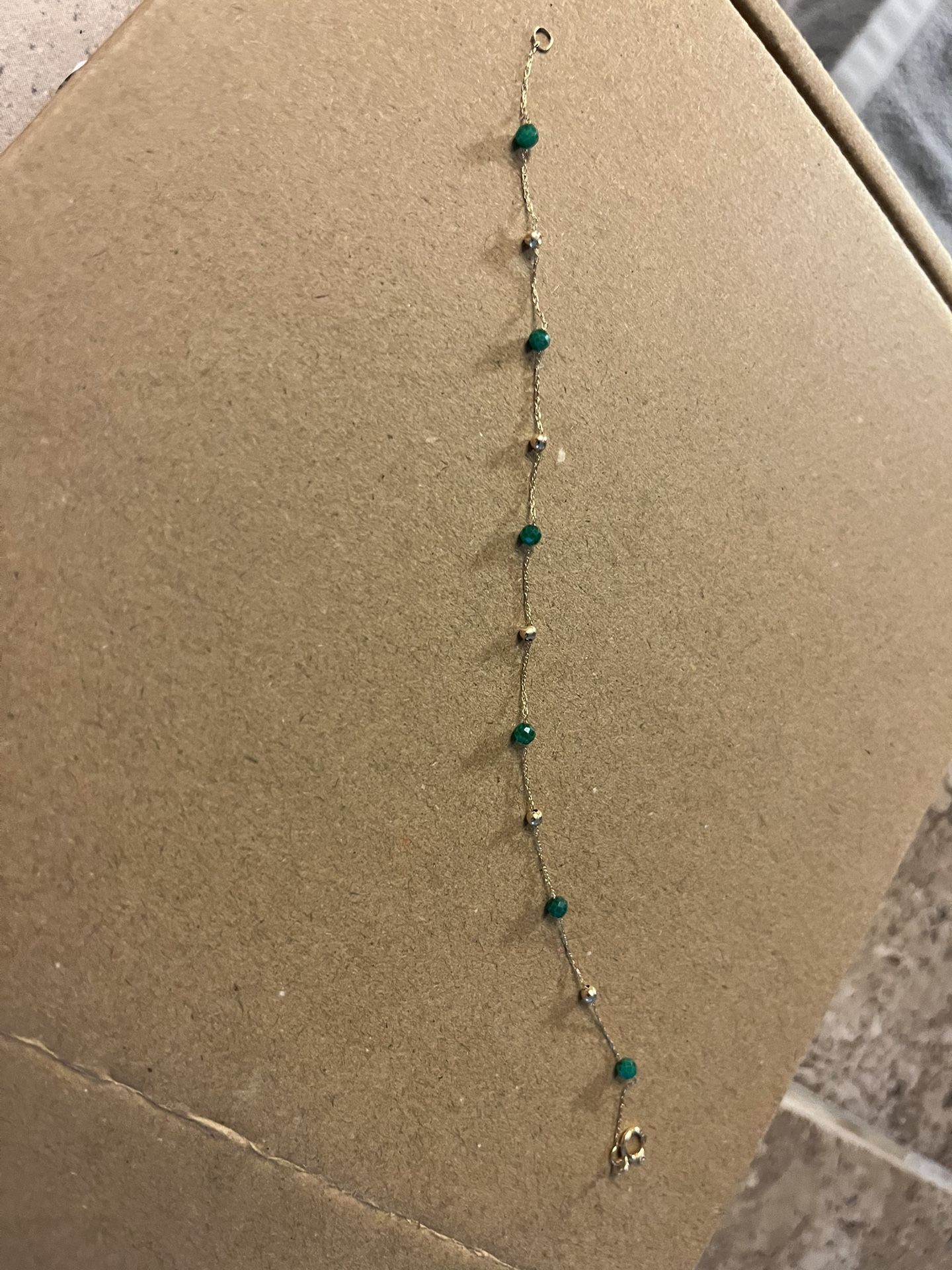 Ladies 14K gold bracelet With Green Stones And Gold Needs