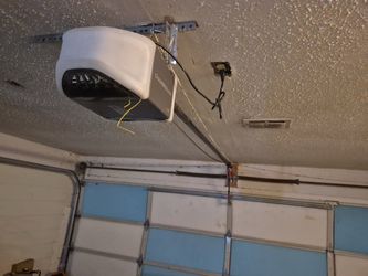 Overhead Garage door opener broken spring off track replace adjustment and parts