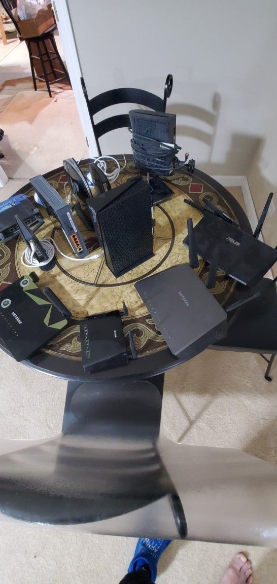 Assorted WiFi Routers , 2 Web Cams And Cable Modem .