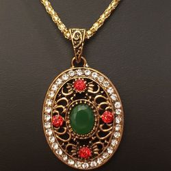NEW Betsey Johnson Necklace.  Gold and the Pendant has Green, Red, & Clear Rhinestones.  Absolutely Beautiful!  Chain is approximately24"-27" long.  I