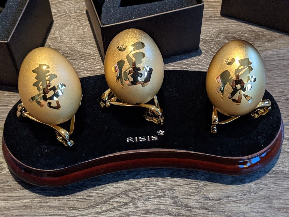 Chinese RISIS Golden Wealth Collection real eggshells encapsulated in 24K Swiss Gold. $688 retail. Includes set of 3 gold eggs. Brand New condition.