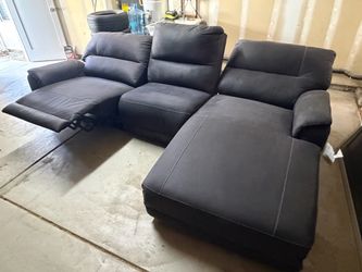Sectional sofa with power chase and recliner.