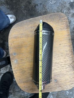 Universal motorcycle exhaust muffler with a carbon fiber pattern finish