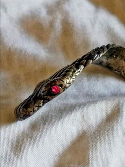 Snake wrap fashion ring with garnet eyes for both men and women.