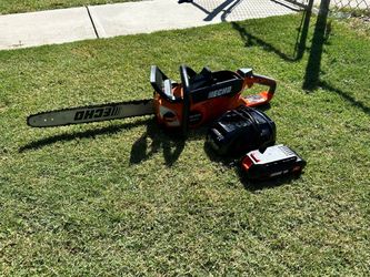 ECHO 56V 18-inch cordless electric chainsaw kit with brushless motor, rear handle, 2.5 Ah battery, and charger.