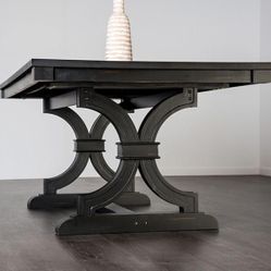 Black Dining Table With Trestle Base And 6 Light Beige Chairs