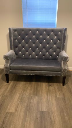 Grey tufted love seat