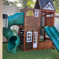 A kids play yard has three slides. A climbing wall two swings had it for about a year and a half in great condition.