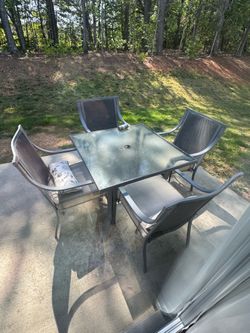 Outside patio table with 4 chairs and umbrella