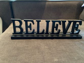 “Believe” black standing sign