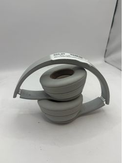 of Beats Solo 4 Wireless On-Ear Headphones in the Drenched Gray finish. Unlike previous versions, the "Drenched" color variants feature fully color-ma