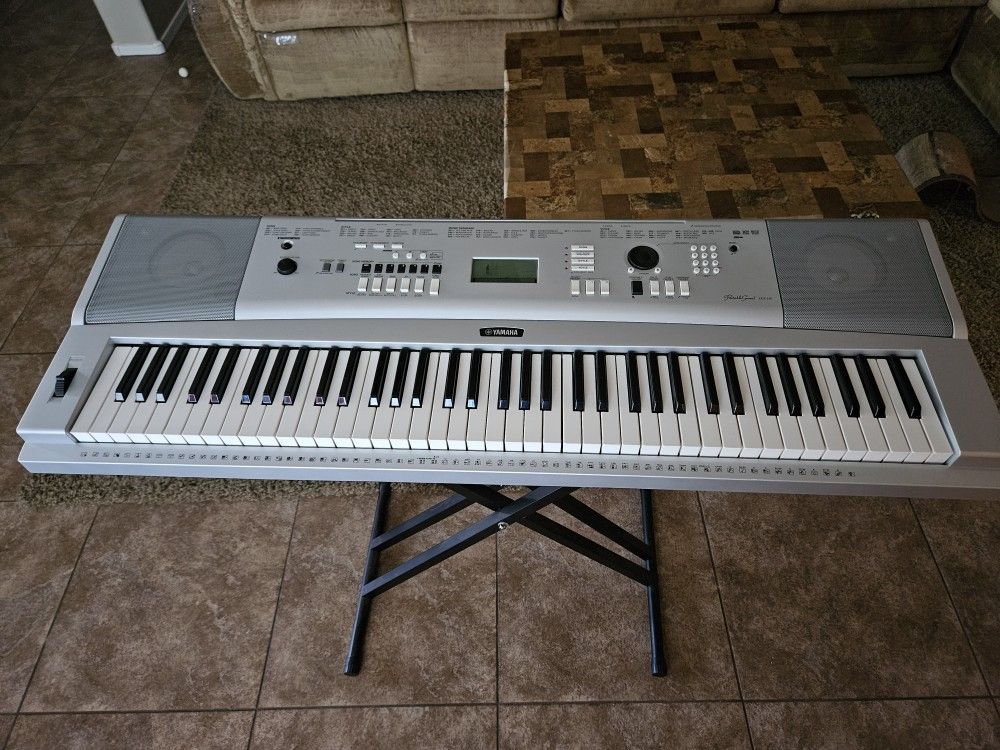 Yahama "Portable Grand" 76-key piano keyboard with stand