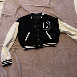 Chic varsity jacket with bold letter detail. Ideal for school and play.
