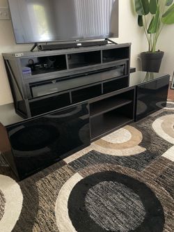 Very nice Black Entertainment center / TV stand. black glass top. adjustable shelves with with both sides