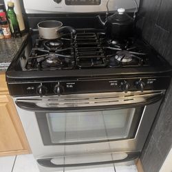 Stainless Steel Refrigerator, Stove And Kitchen Table And Chairs 