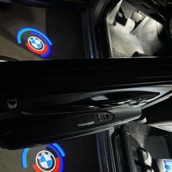 4 BMW 5OTH anniversary door logo lights. Other BMW logo lights, BMW Rim Center Caps, BMW seat belt pads, BMW emblems,BMW tire valve caps Sold Separate