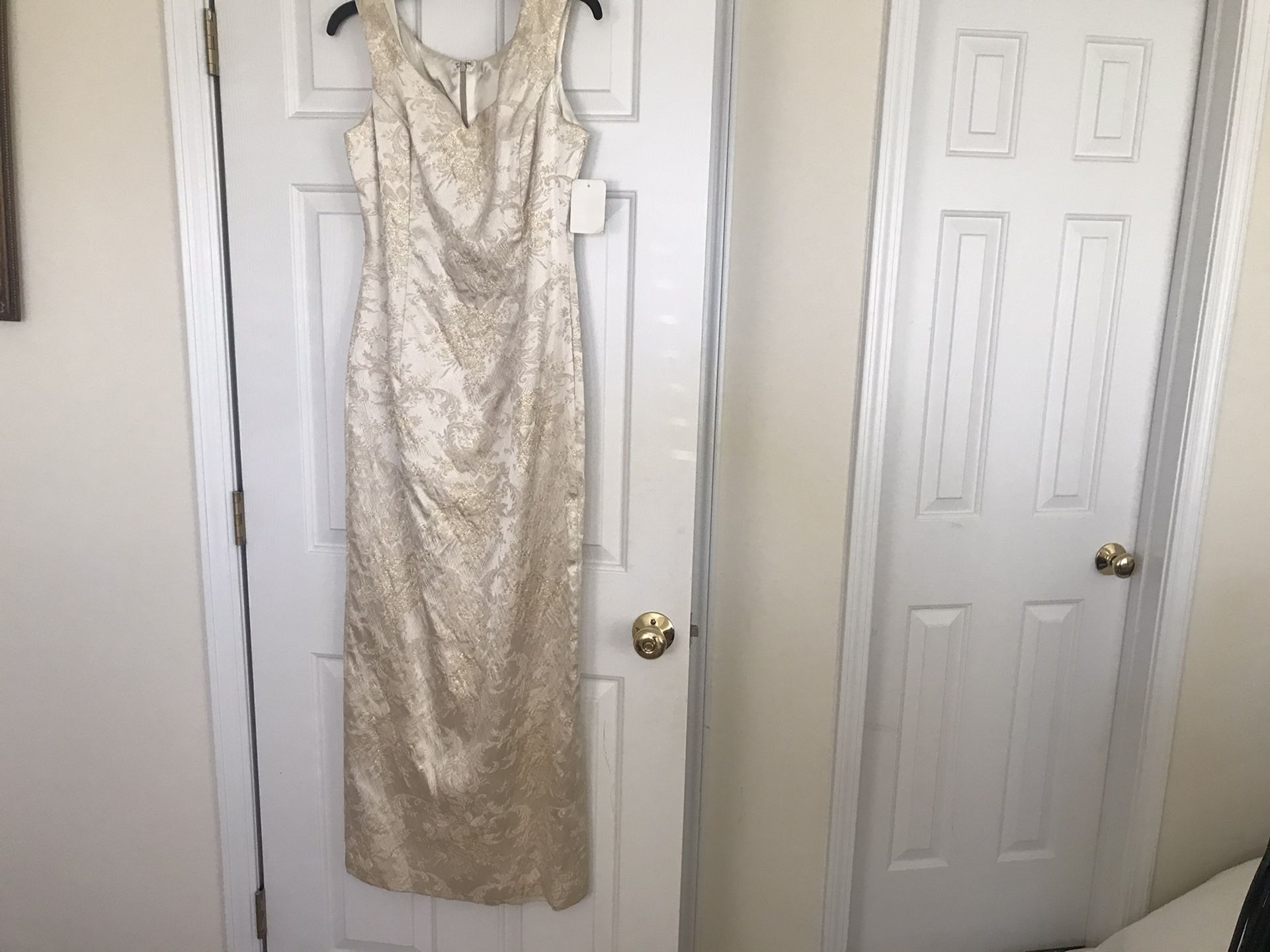 Full length size 12 evening gown. Has cold threading and cream color. $40.00