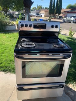 GE Stainless steel and black  electric range with 4 burners