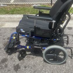 Quickie Iris Tilt In Space modular adjustable Wheelchair. Used in good condition with minor cosmetic blemishes. These blemishes are in the form of scr