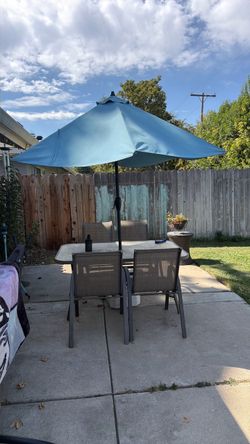 Patio table and chairs with umbrella and stand