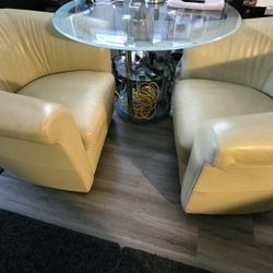 Soft Leather Arm Chairs On The Wheels With Glass Table 